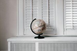 beige desk globe on white desk