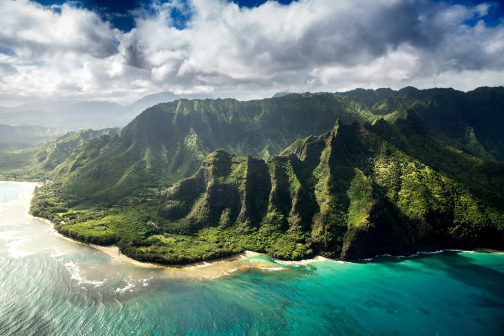 Hawaii.Aerial photography of green mountain beside body of water under white sky