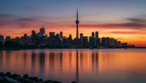 Stunning Toronto skyline at sunset featuring the CN Tower reflecting on Lake Ontario
