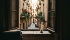 View from a cozy hotel window in the Gothic Quarter of Barcelona showing rustic wrought-iron balconies