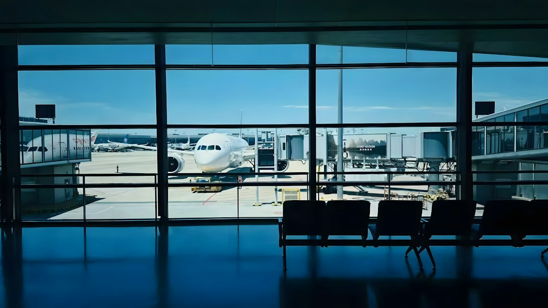 Aircraft at an airport gate illustrating a trip delay or disrupted vacation