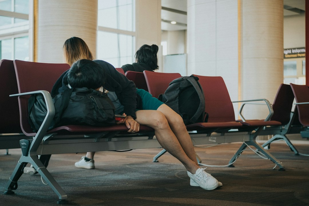 Traveler sleeping at an airport while waiting to board