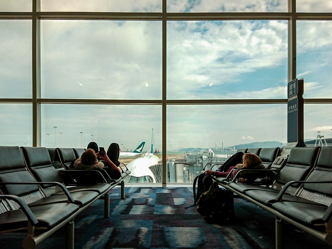 Travelers resting at an airport while waiting for a flight