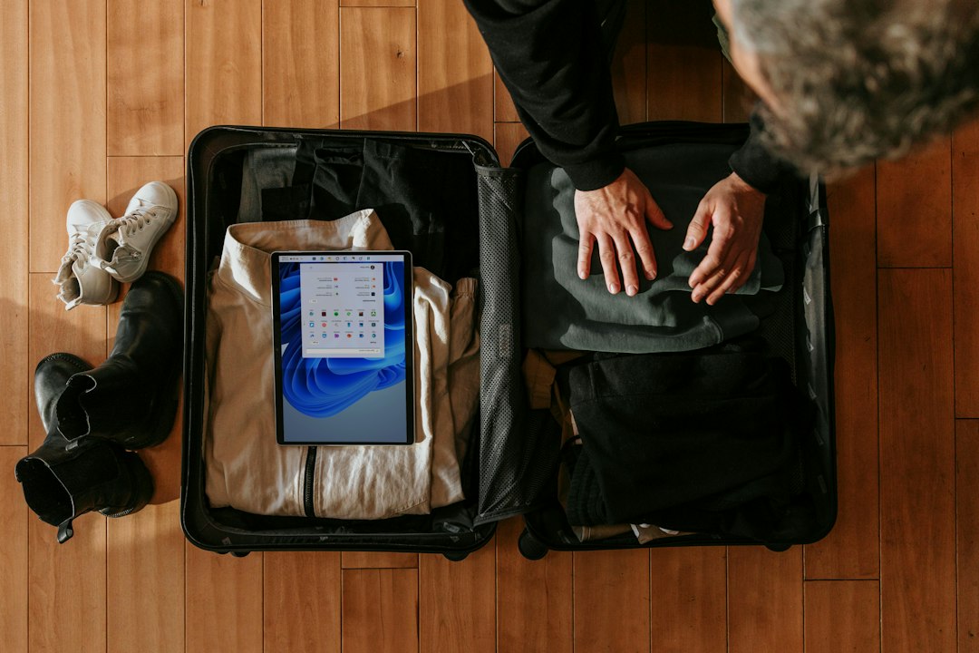 Traveler packing a suitcase for a light travel wardrobe