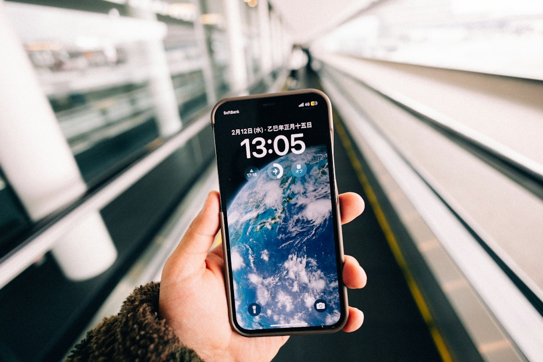 Traveler using a smartphone while moving through an airport